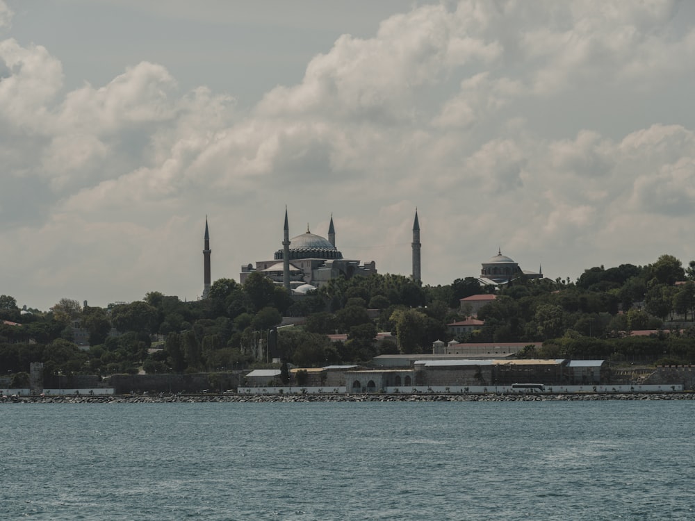 a body of water with buildings and trees around it