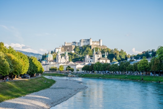 Salzburg - a river with a castle on the hill behind it