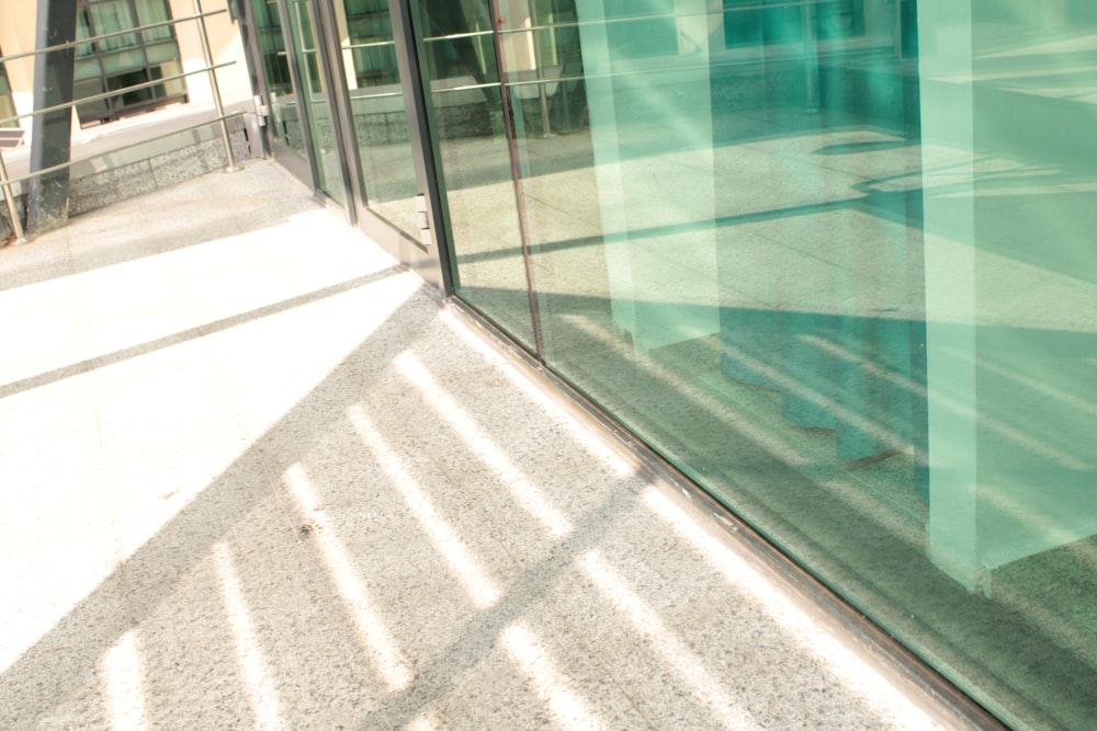 a glass wall with a tile floor