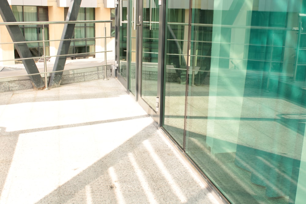 a glass wall with a metal fence