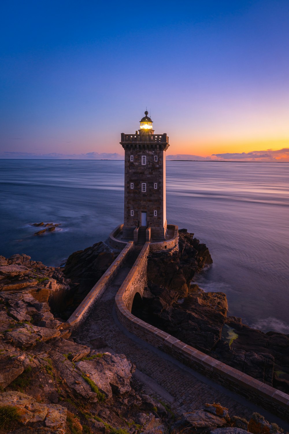 a lighthouse on a rocky cliff