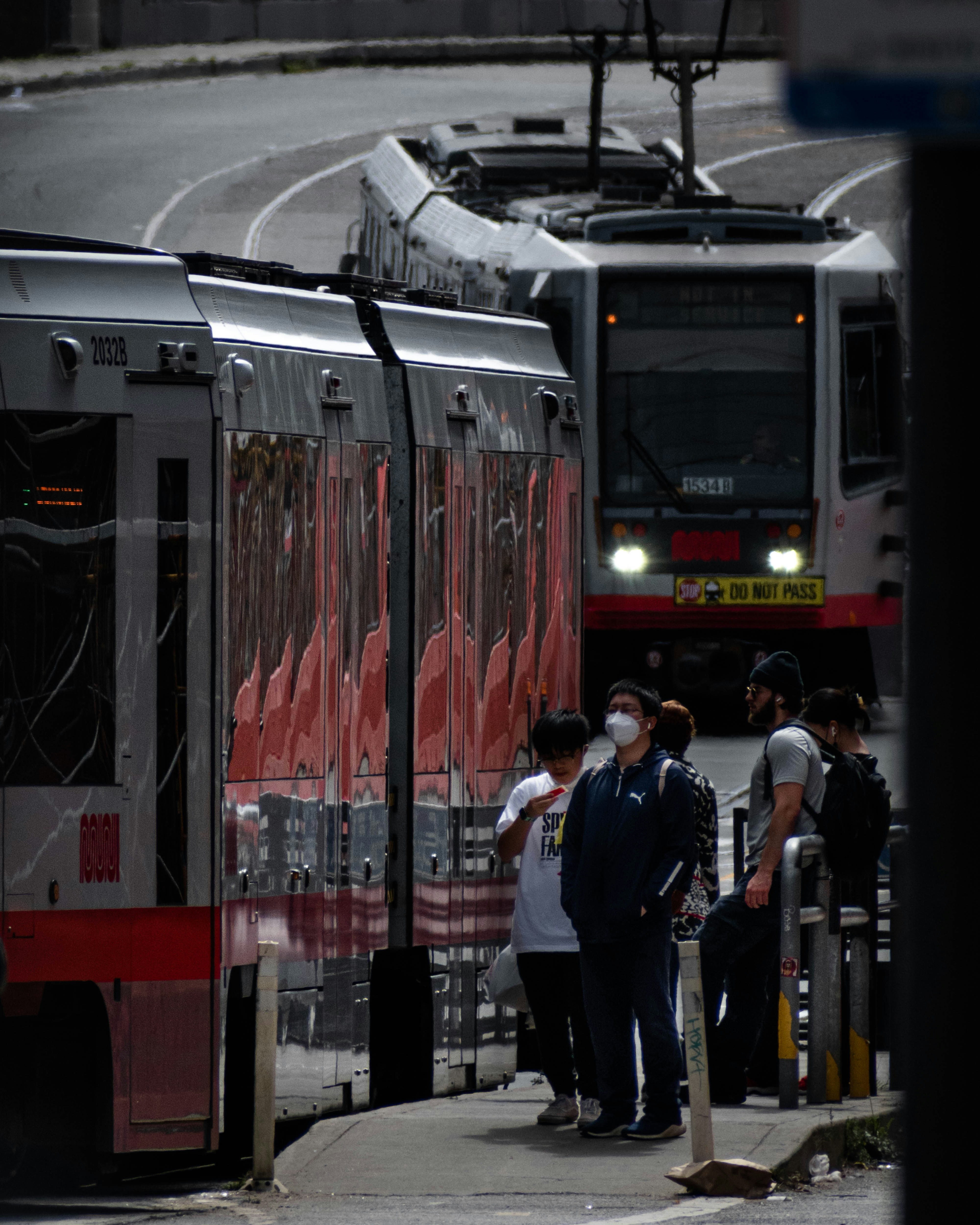 a group of people standing next to a train