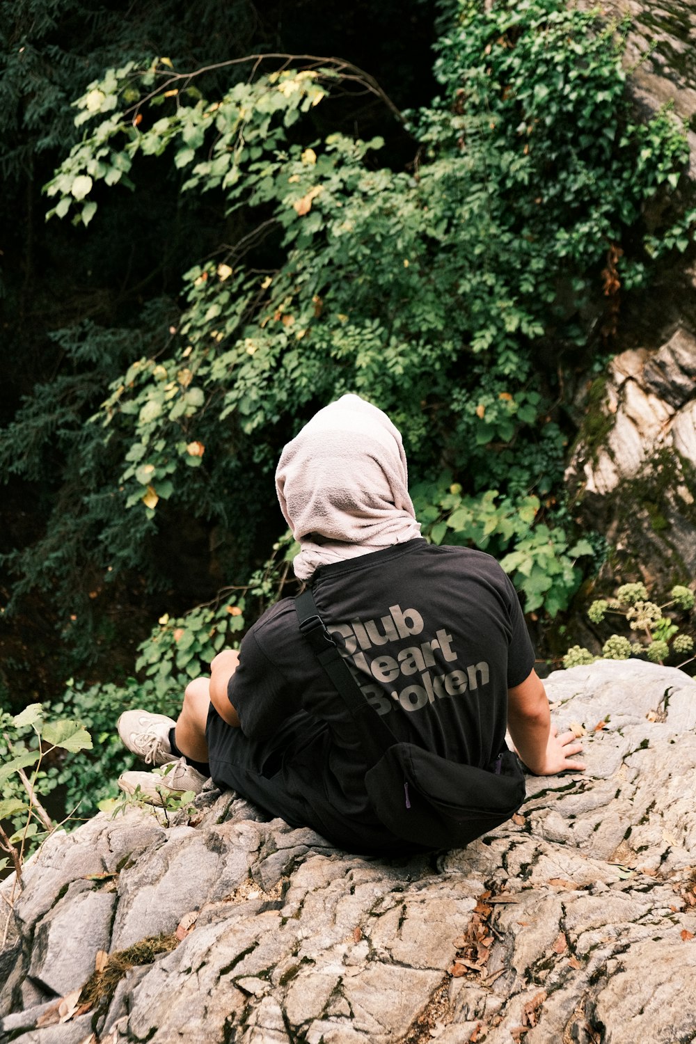 a person sitting on a rock