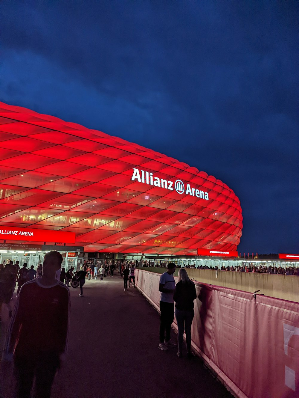 people walking near Allianz Arena