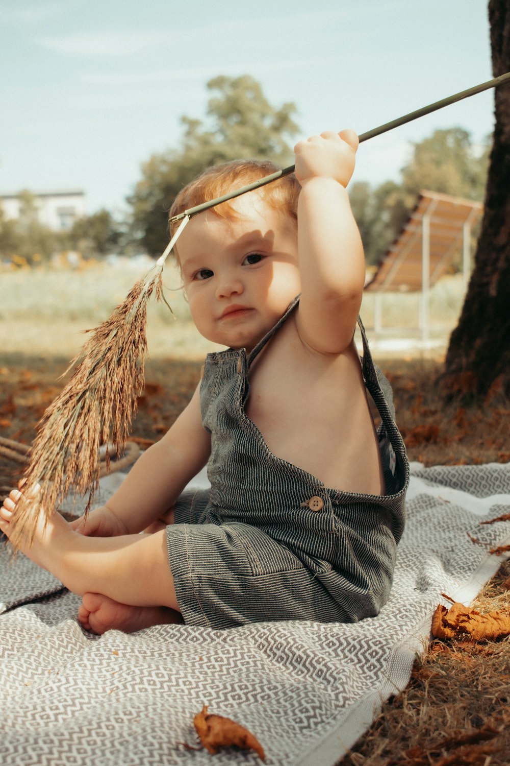 a baby girl sitting on a blanket