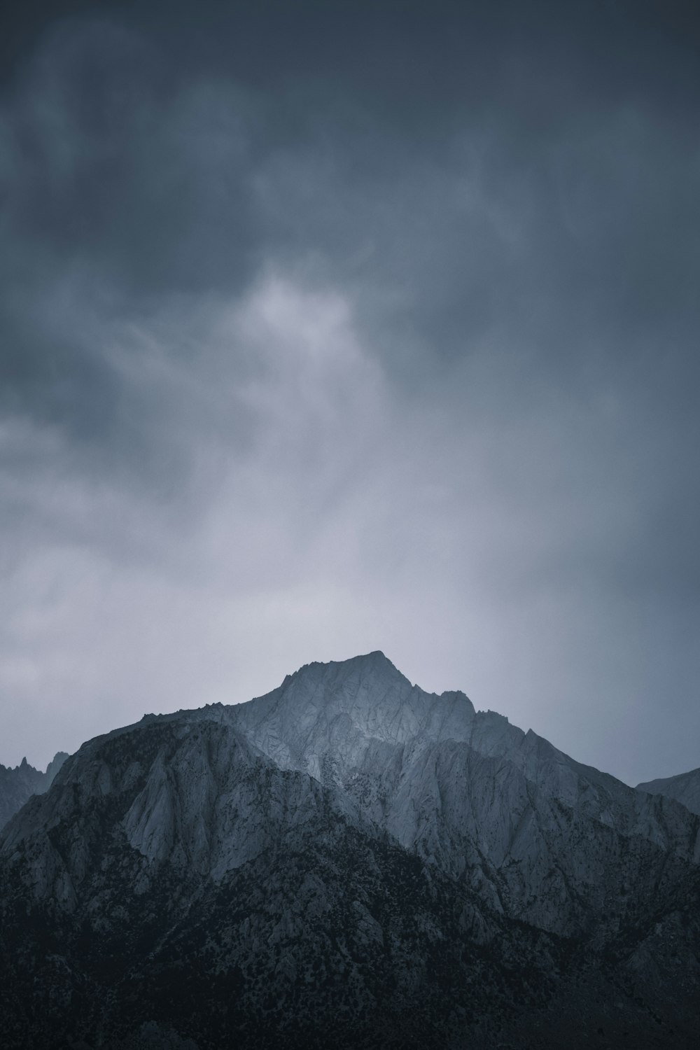 a mountain with clouds above it