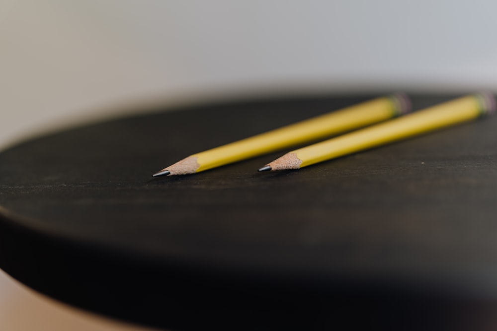a pencil on a black surface