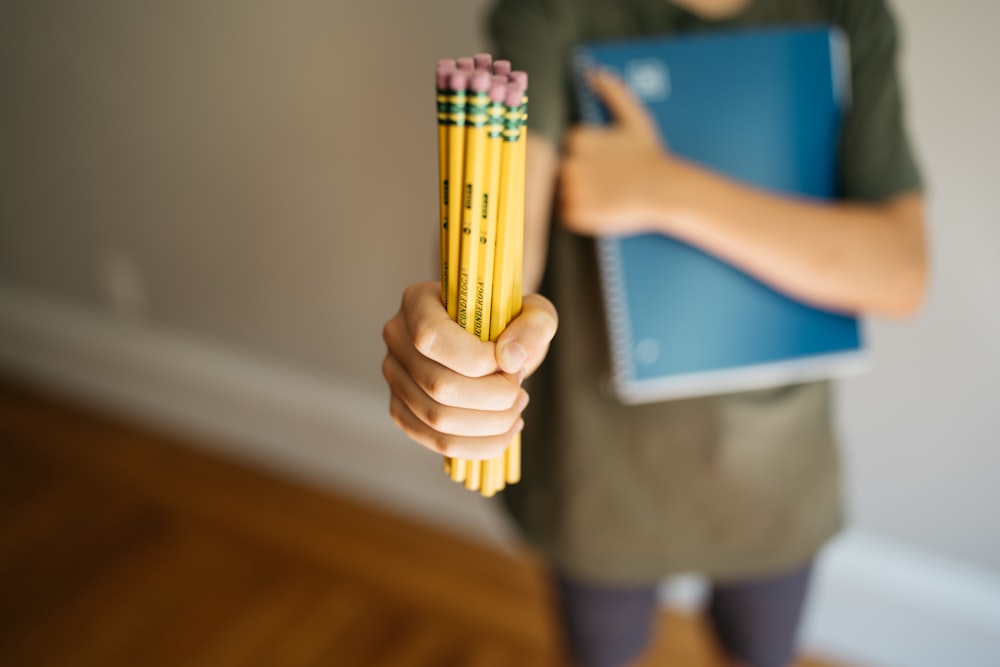 a person holding a yellow lighter