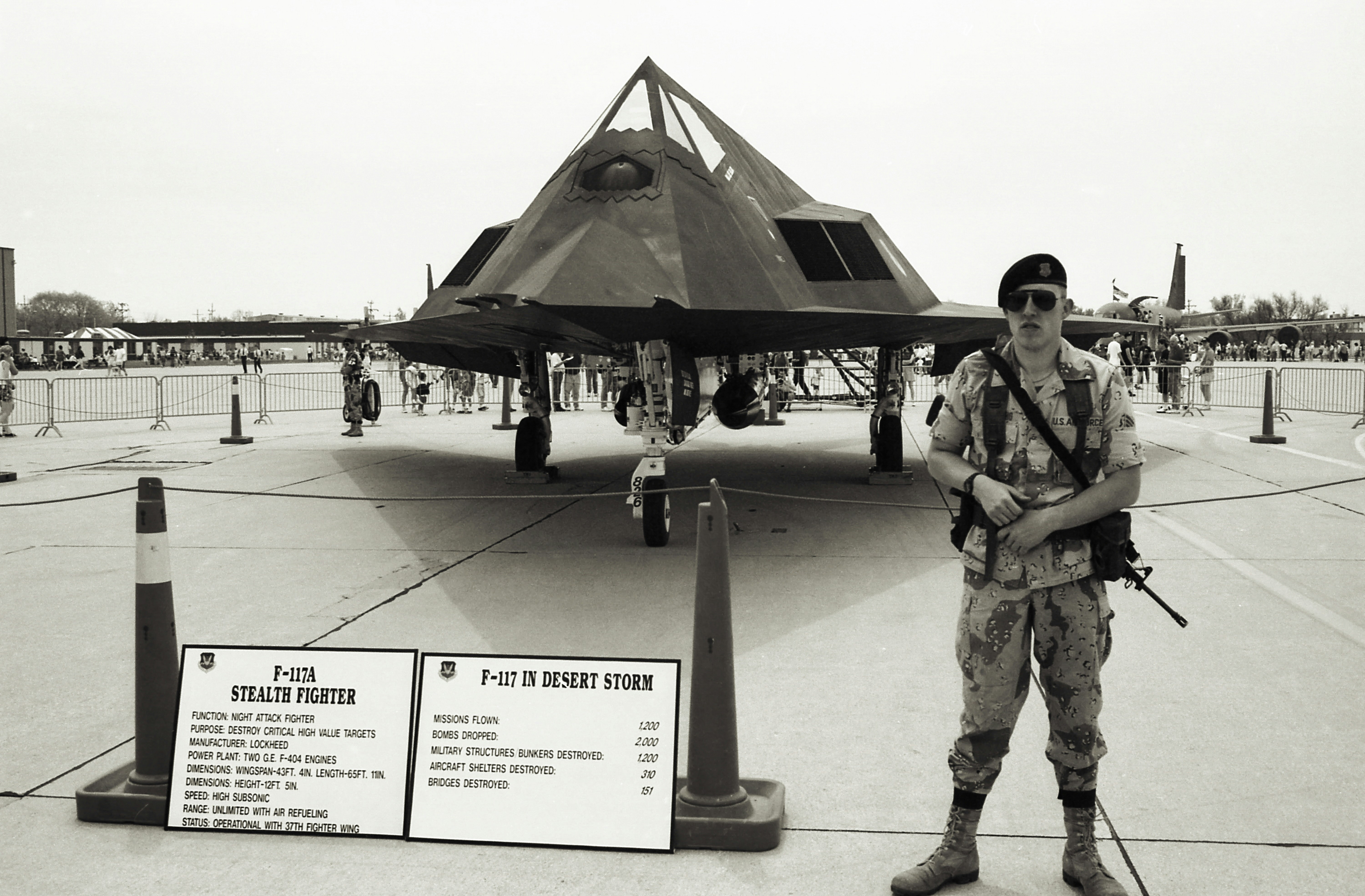 a man standing next to a plane,  Photo was made from scanned 35mm film.