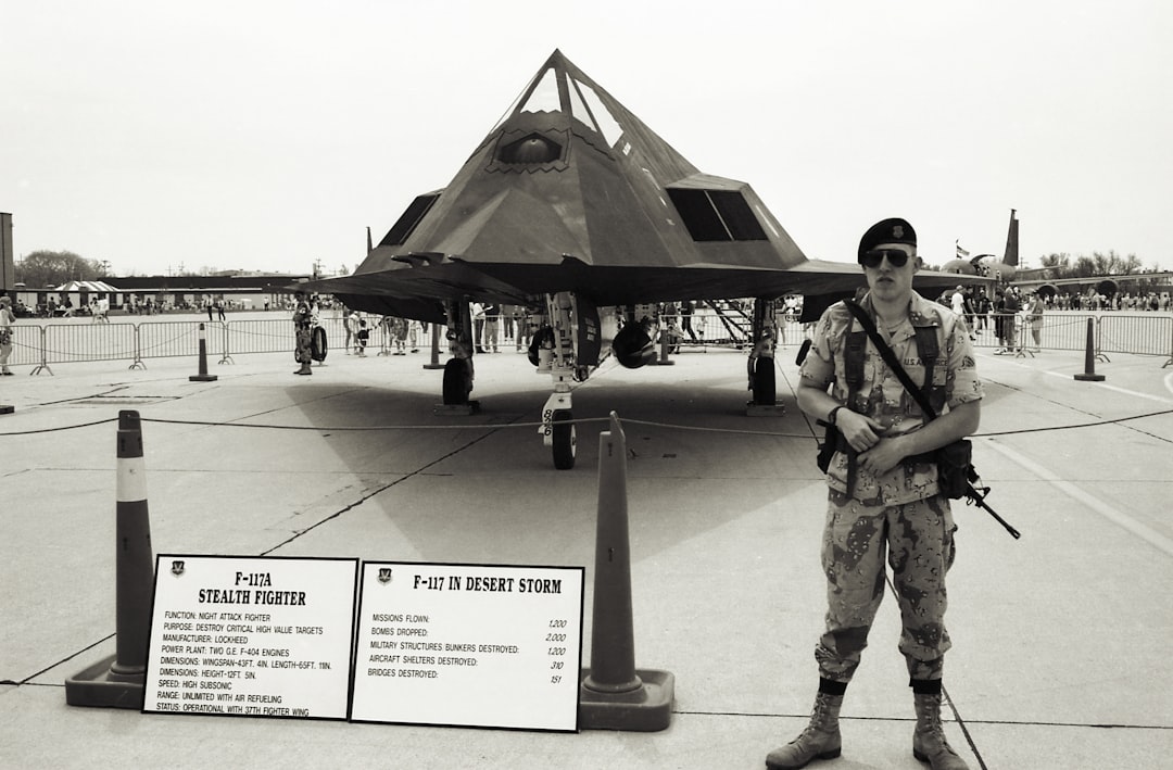 a man standing next to a plane, Photo was made from scanned 35mm film.