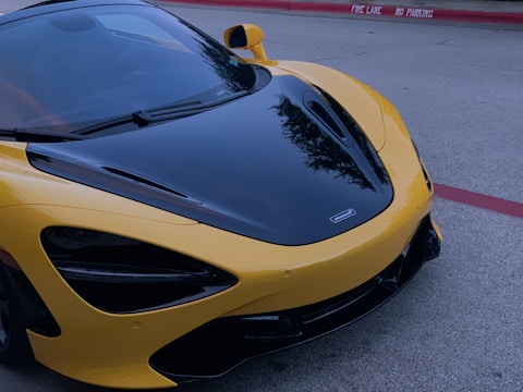 A sleek car parked with a 'Sold' sign on the windshield.