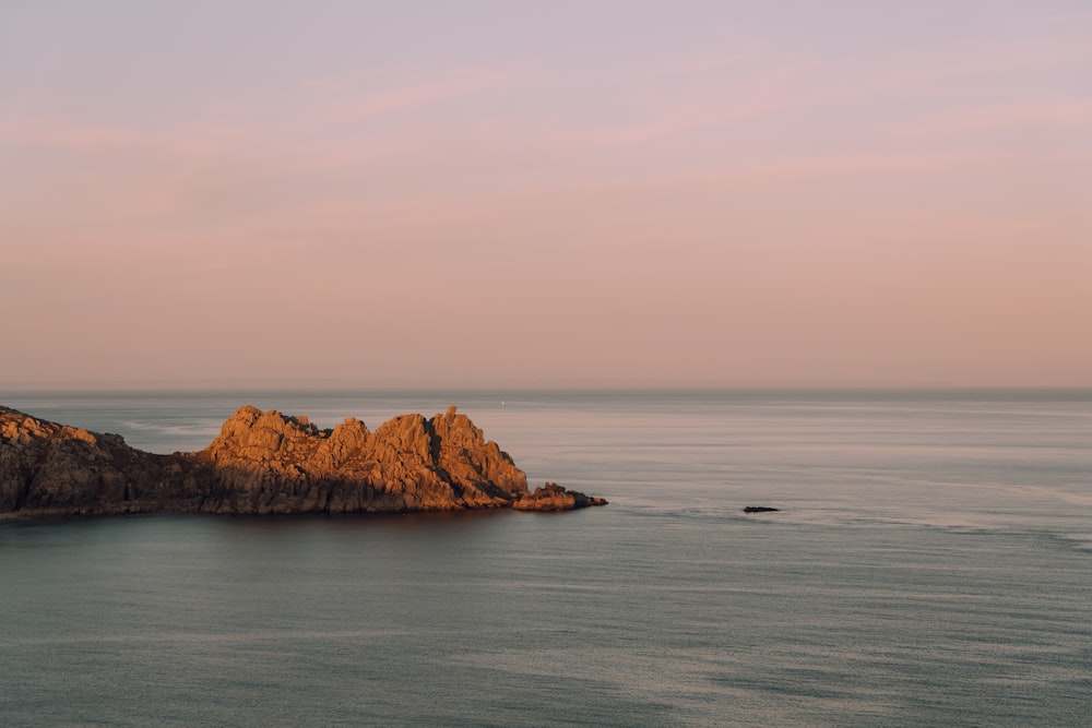 a rock outcropping in the middle of the ocean