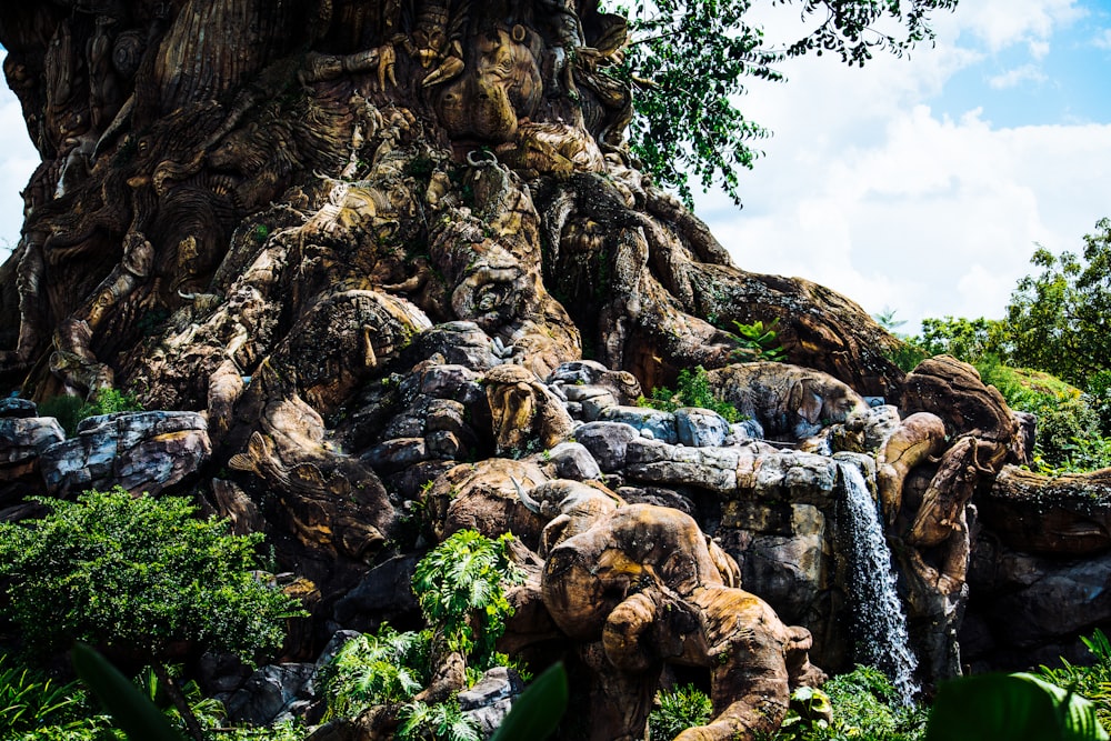 a rocky cliff with a waterfall