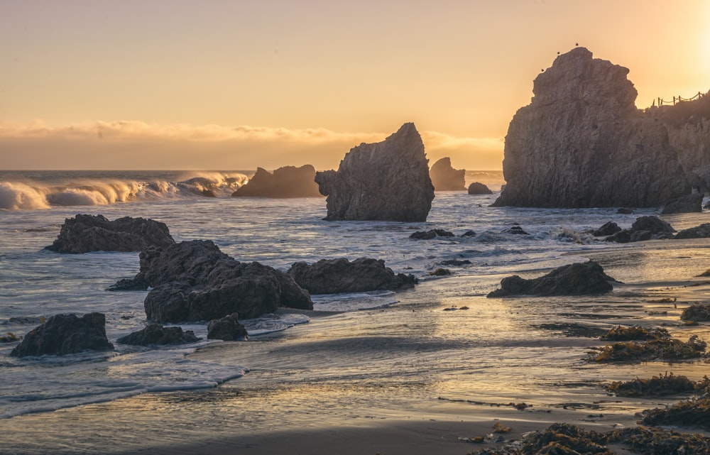 a beach with rocks and water