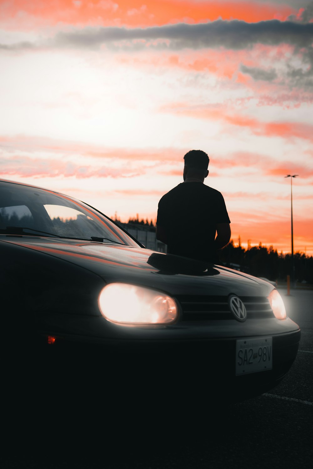 a person standing next to a car