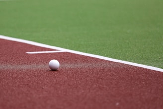 a golf ball on a red field