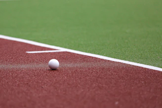 a golf ball on a red field