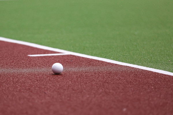 a golf ball on a red field