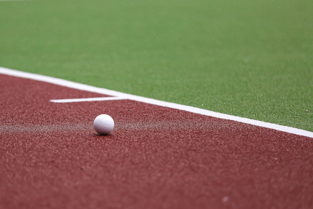 a golf ball on a red field