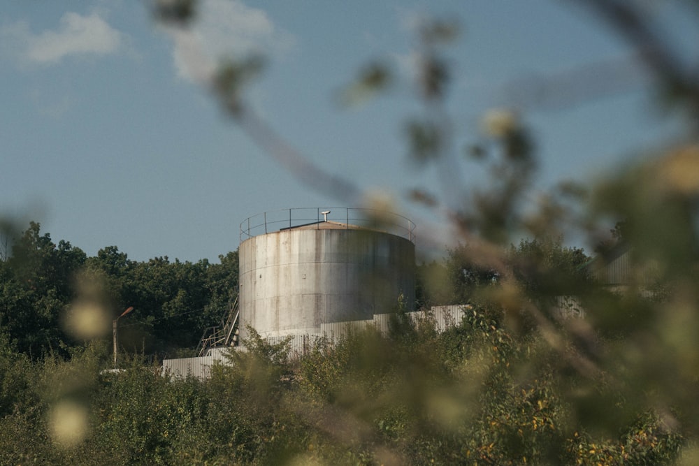 a large silo with smoke coming out of it