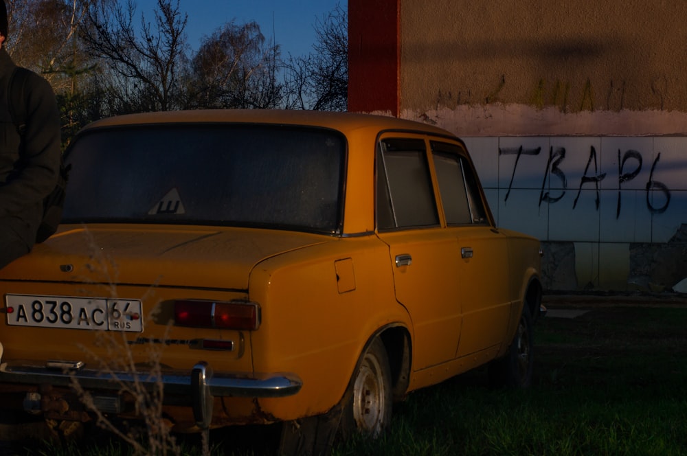 a yellow car parked in front of a building