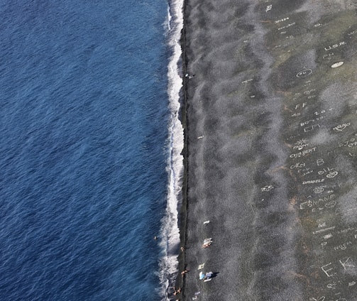 a plane flying over a beach