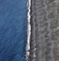 a plane flying over a beach