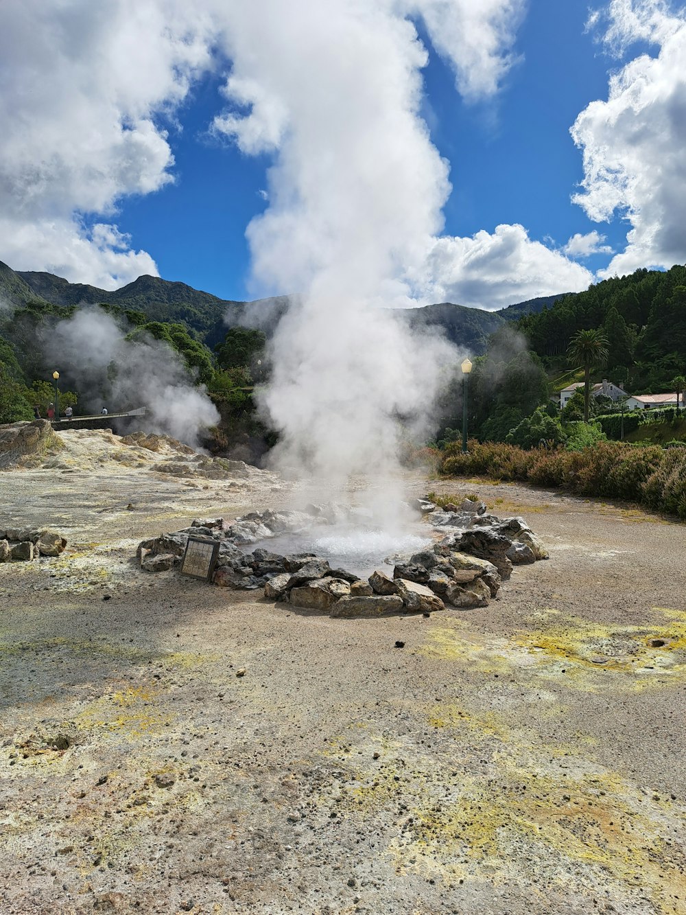 a large geyser in a rocky area