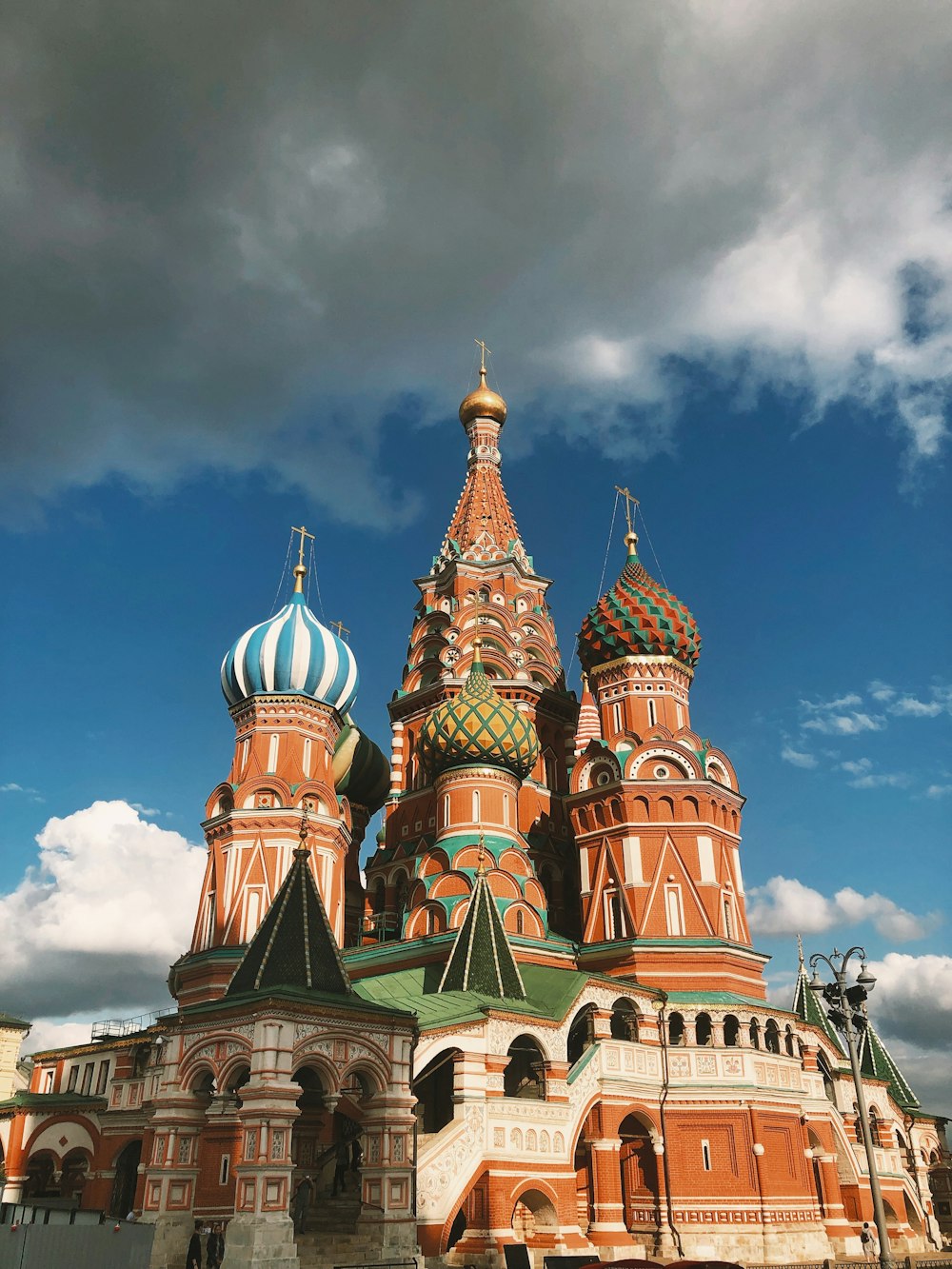 a large ornate building with colorful domes with Saint Basil's Cathedral in the background