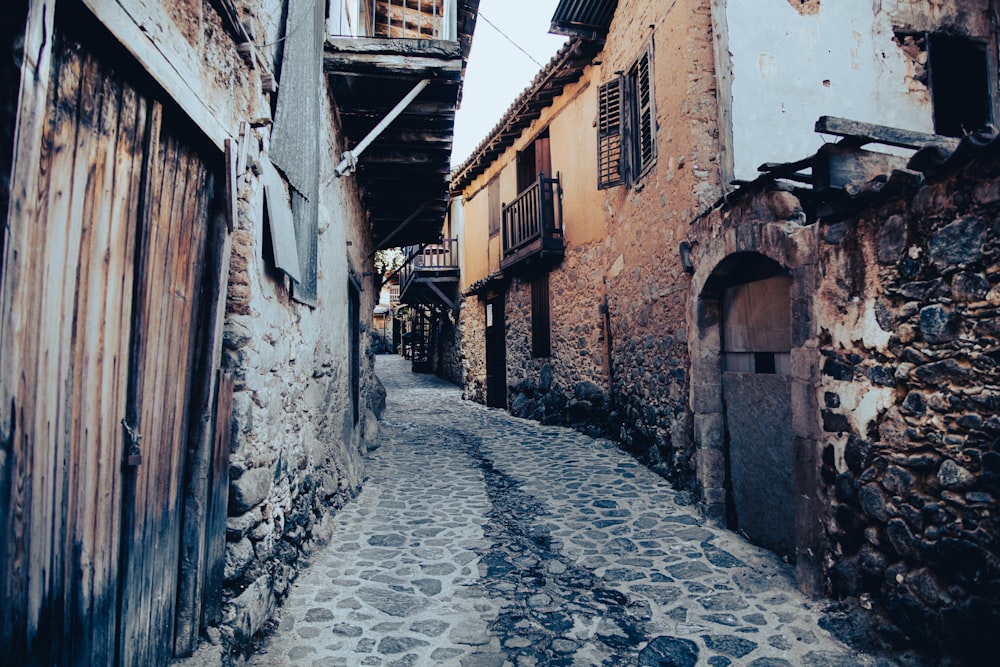 a cobblestone street between buildings