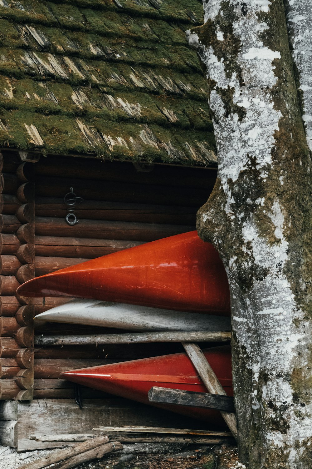 a couple of boats sit in a wooden cabin