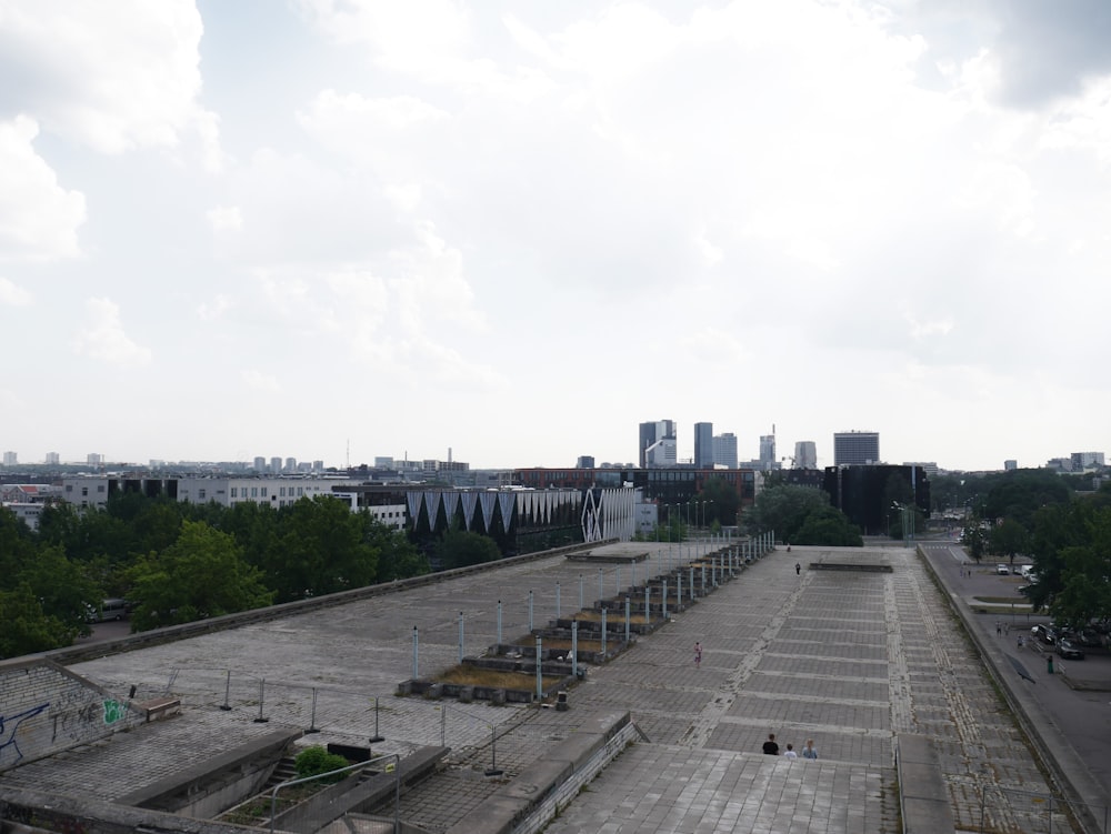 a large concrete area with a city in the background