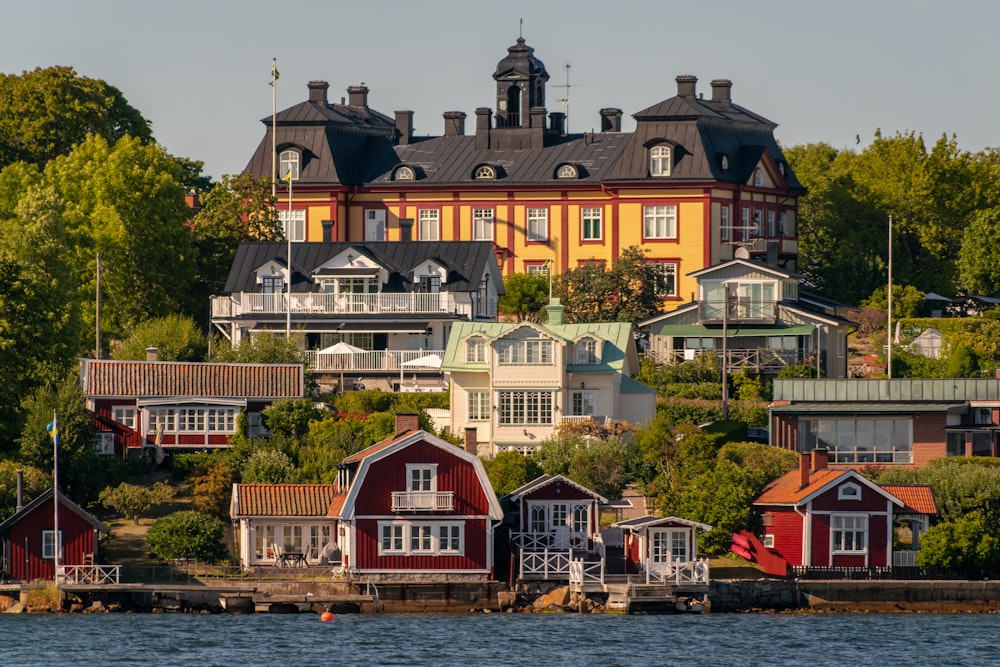 a group of houses next to a body of water