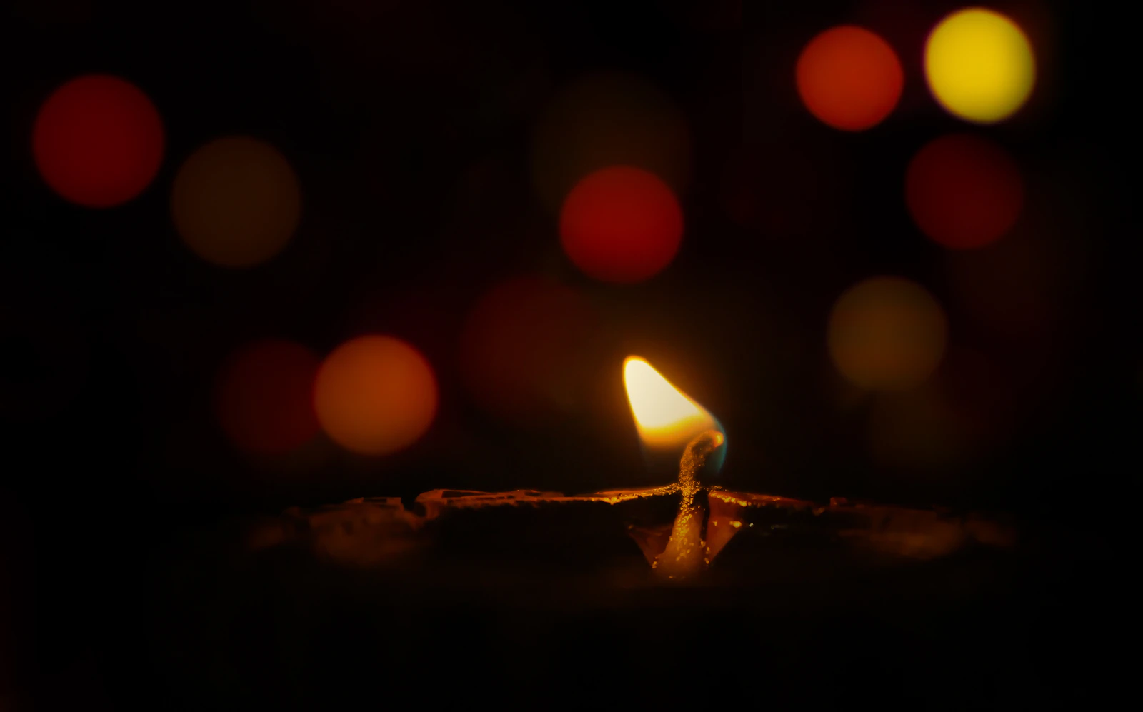 A single candle burning in the dark