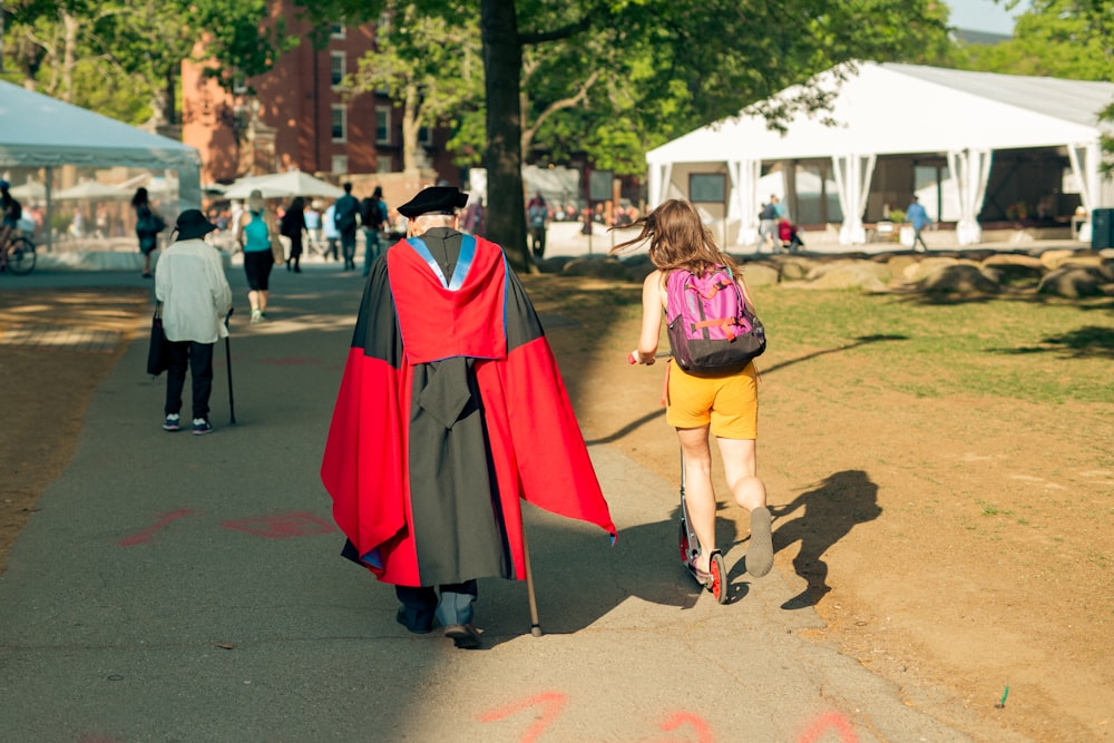 a person in a garment walking with a child