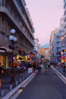 A vibrant street scene in Kinshasa showing diverse community life under soft afternoon light