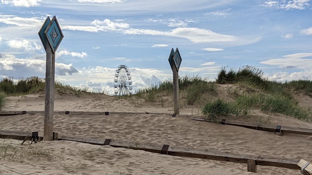 a boardwalk with a ferris wheel in the background