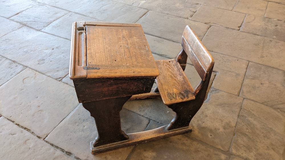 a couple of wooden chairs on a tile floor