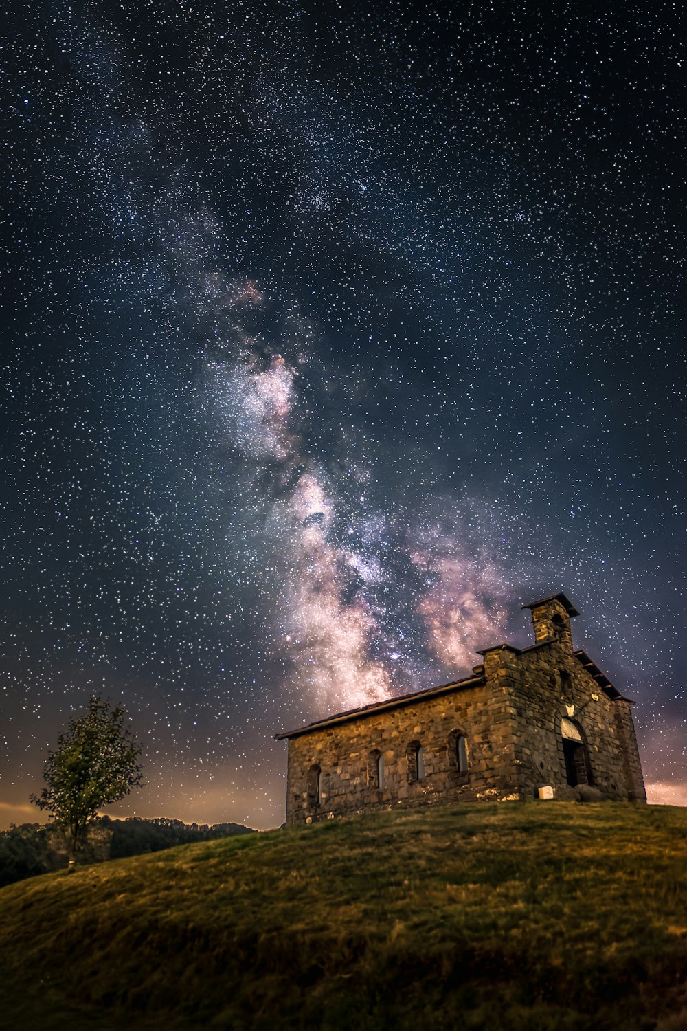 a building with a light in the sky above it