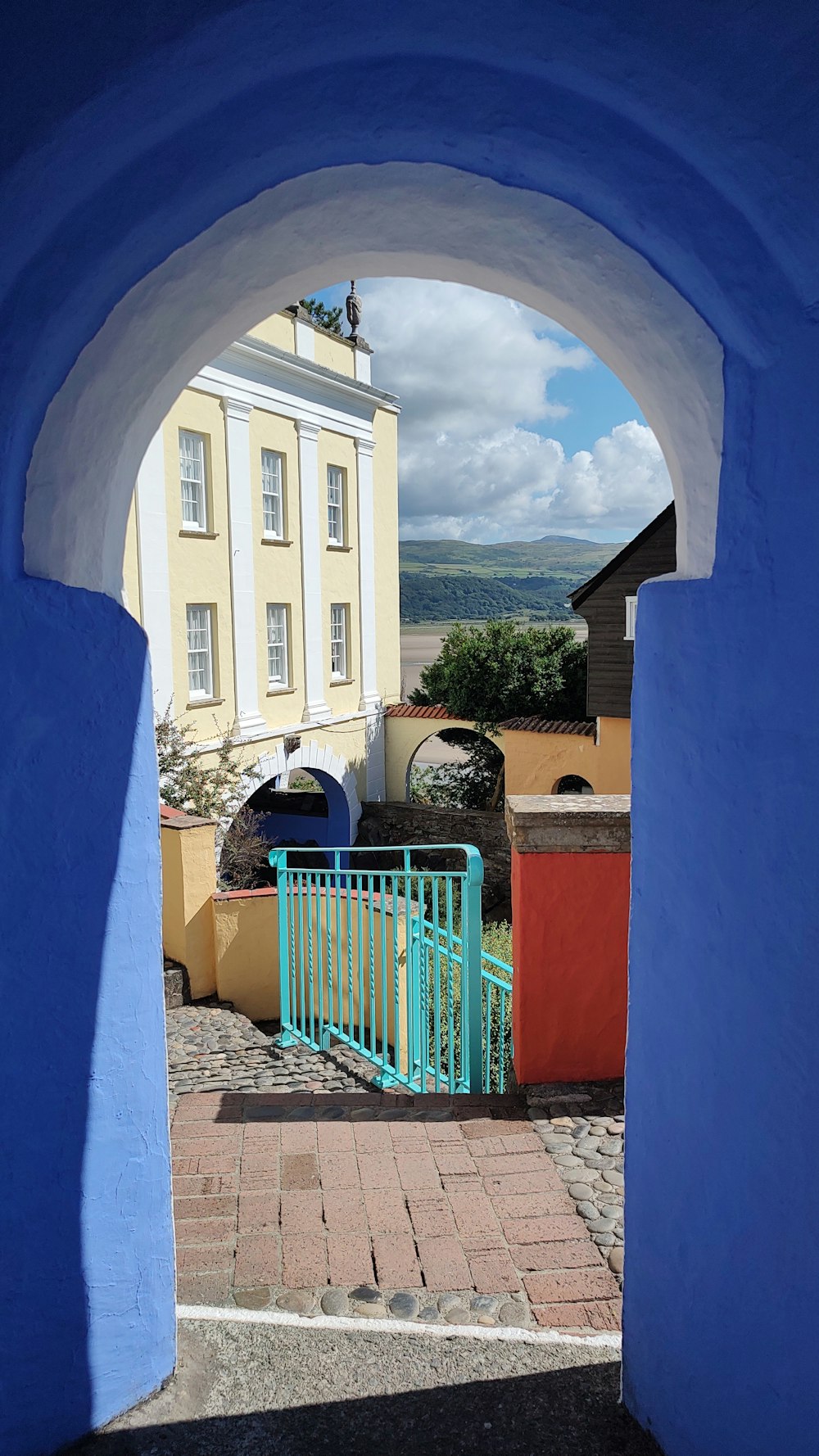 a blue gate in a stone building
