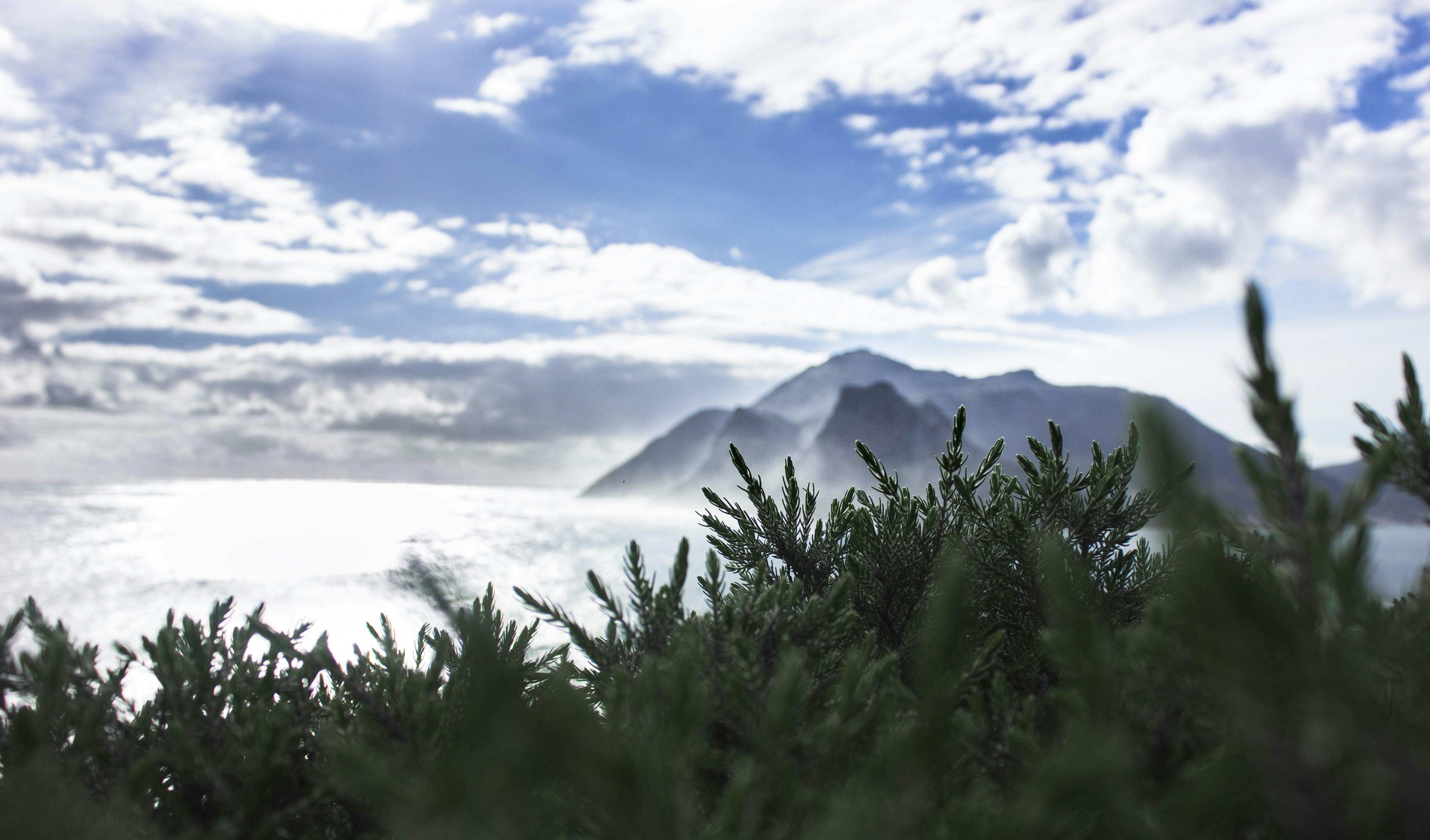 a view of a mountain and clouds
