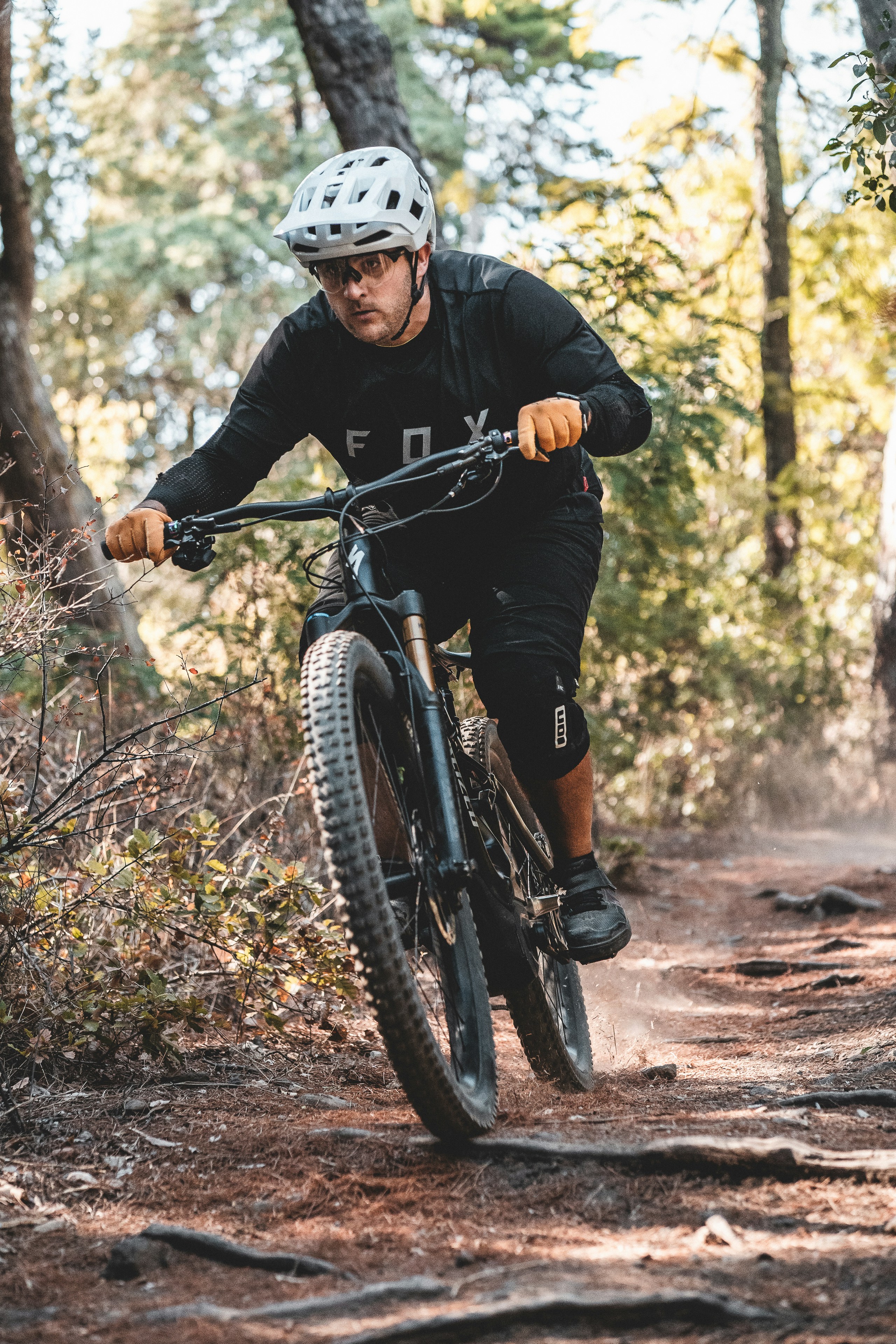a man riding a bike on a trail in the woods