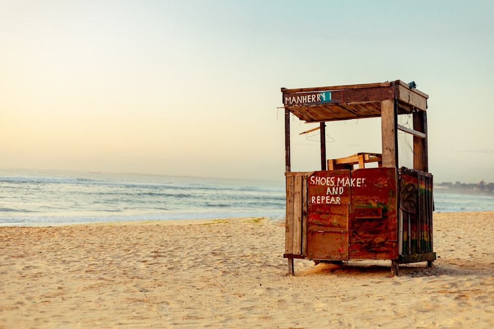 a small wooden structure on a beach