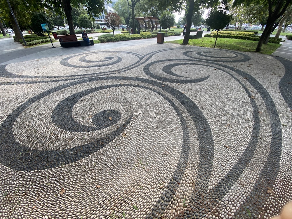 a paved area with trees and grass