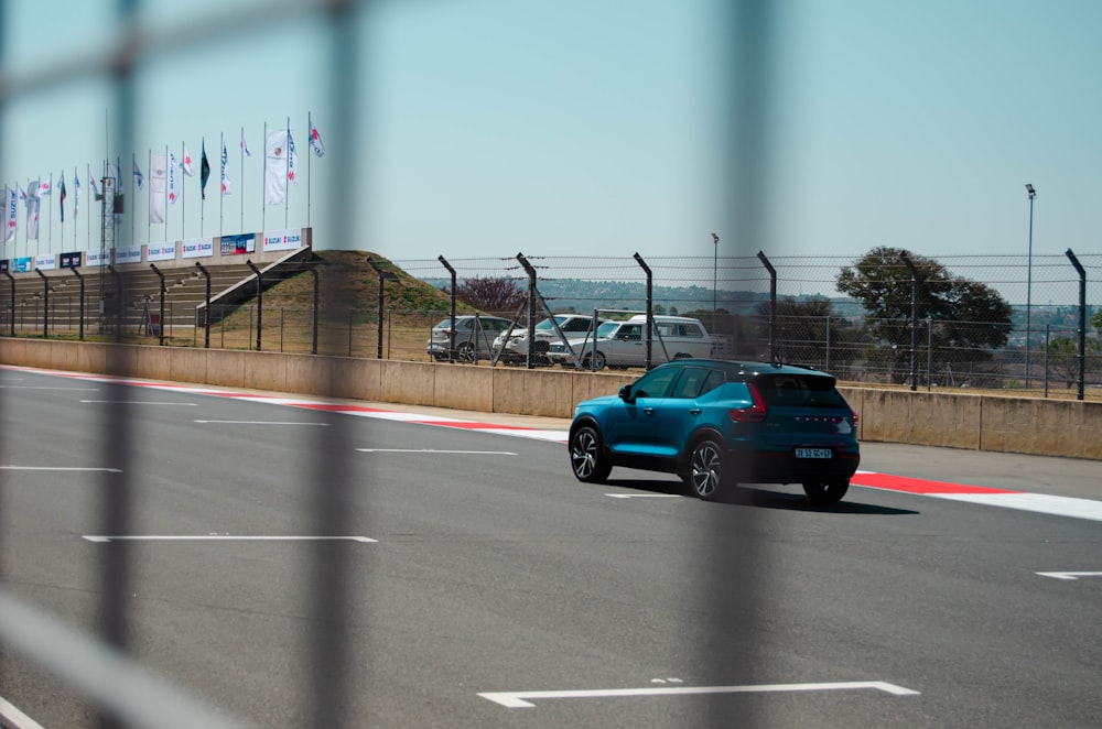 a blue car on a road