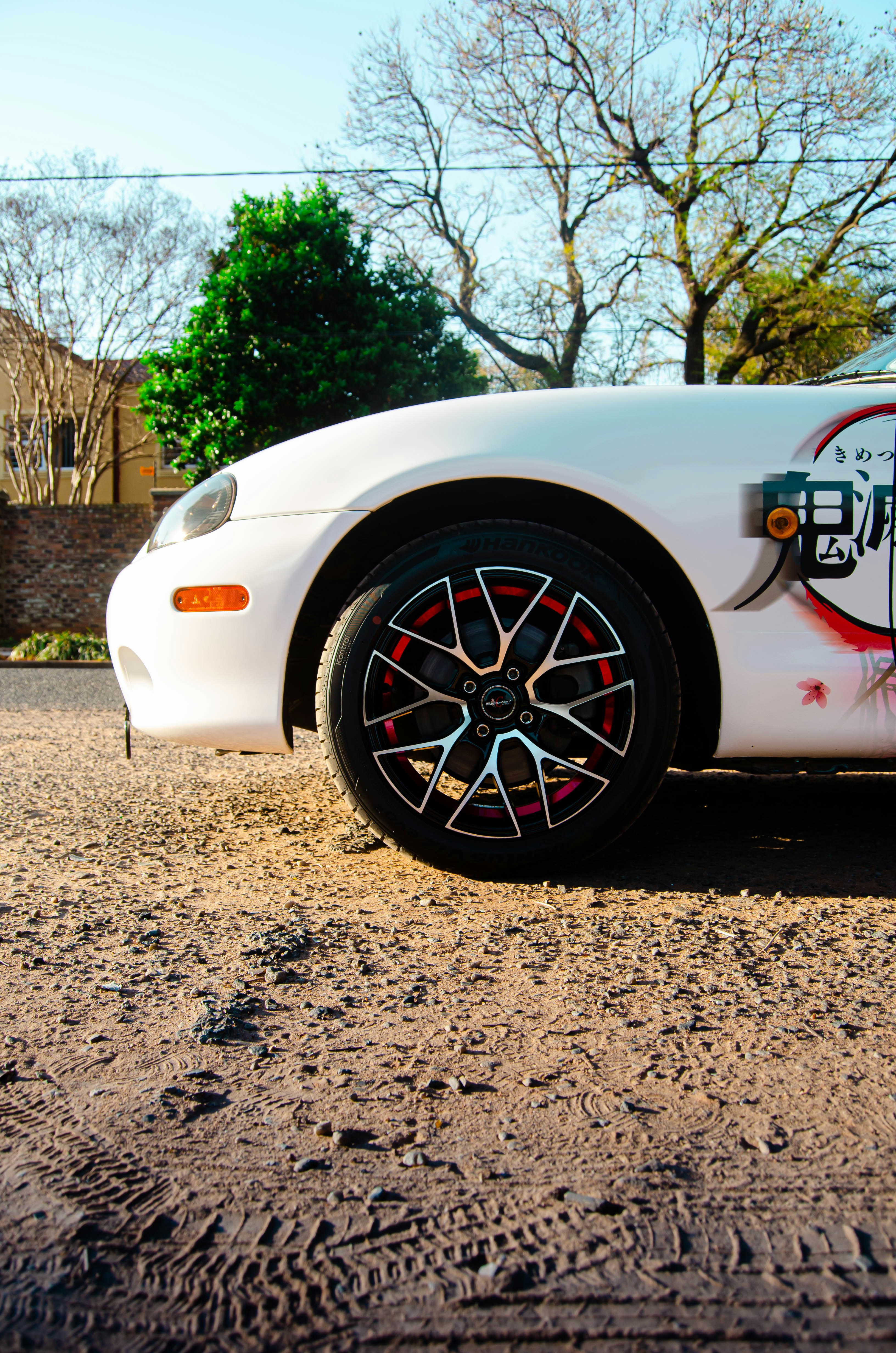 A white car with red rims photo – Free Race car Image on Unsplash