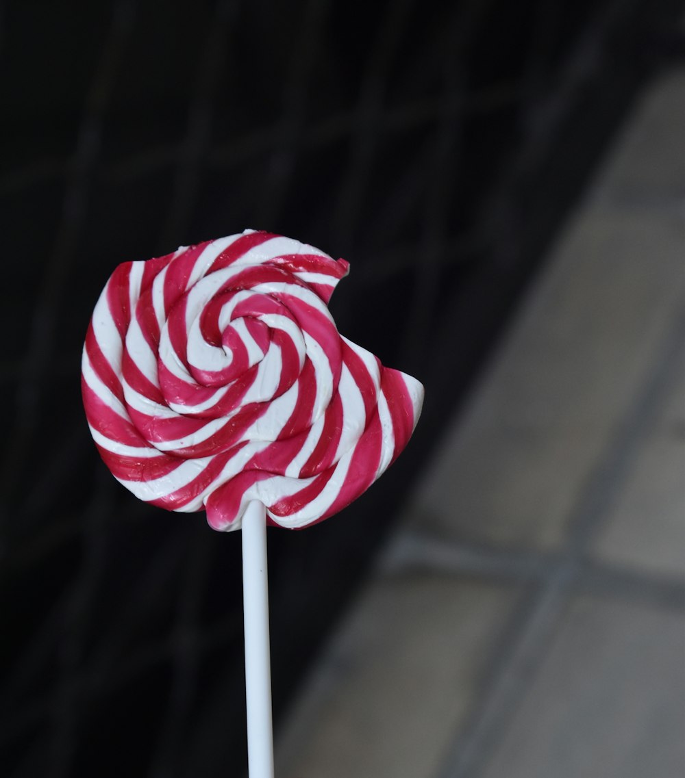 a red and white striped lollipop