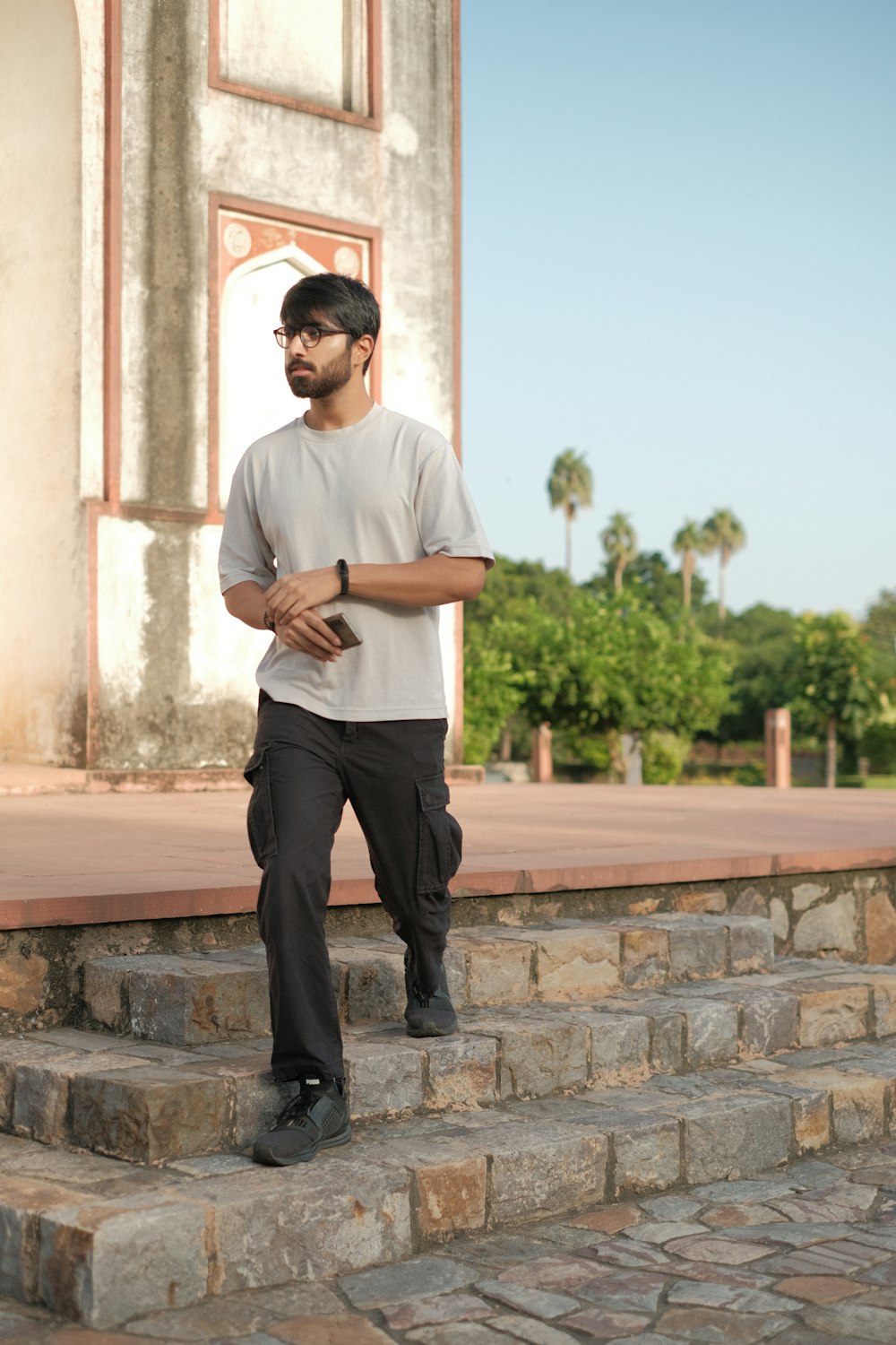 a man standing on a stone wall