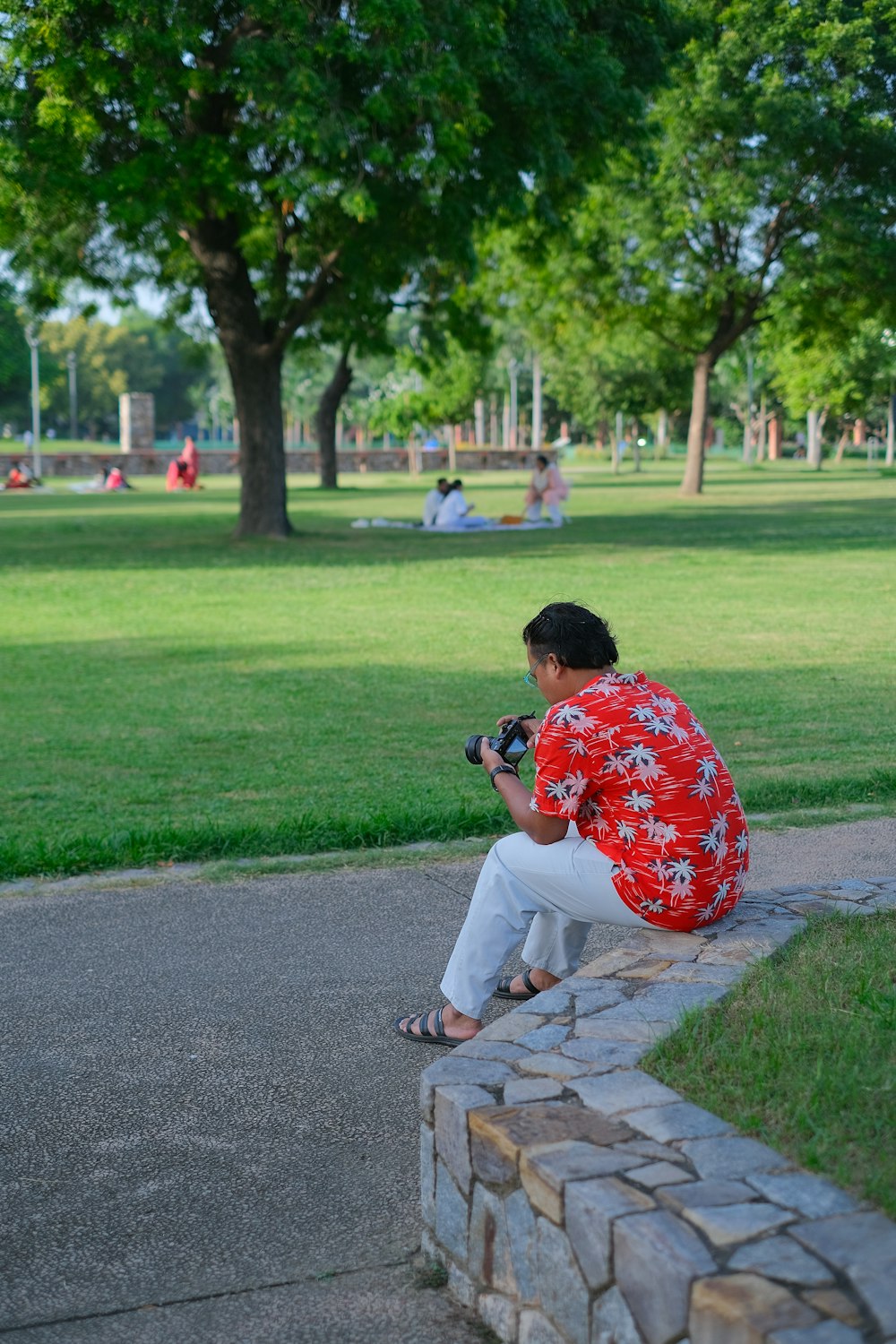 a person sitting on a stone wall