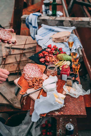 A rustic wooden table showcasing an assortment of Spanish cheeses with almonds scattered around.